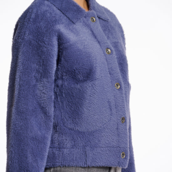 short fluffy blue jacket with collar, button down and 2 patch pockets side view 