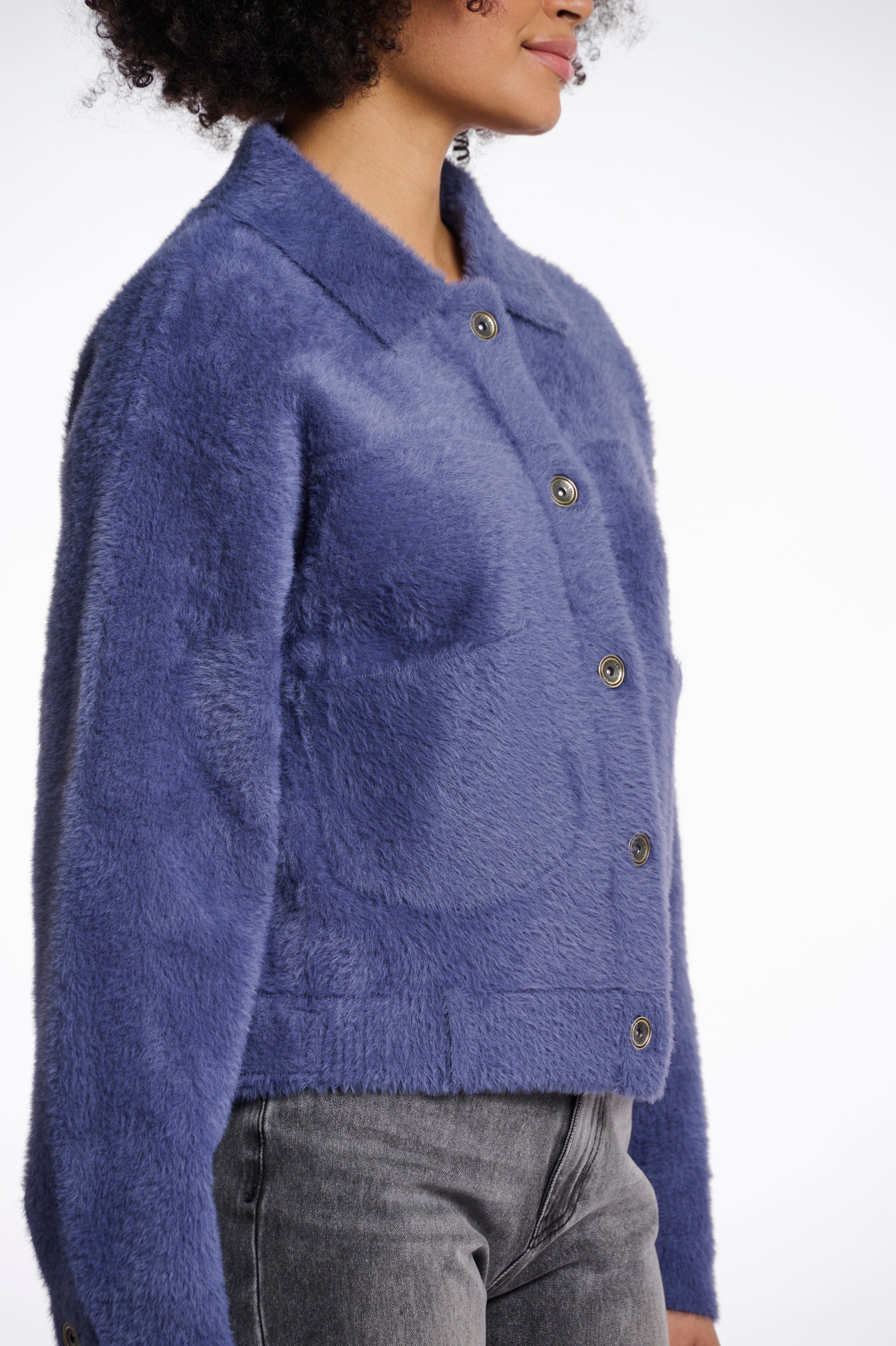 short fluffy blue jacket with collar, button down and 2 patch pockets side view 