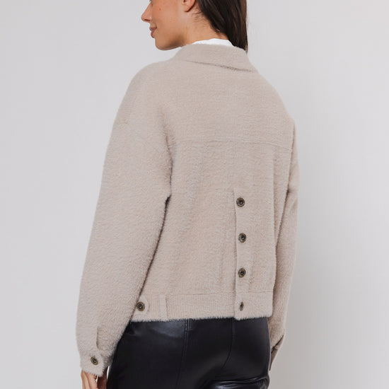 boxy beige soft cardigan with 2 front patch pockets and traditional collar rear view 