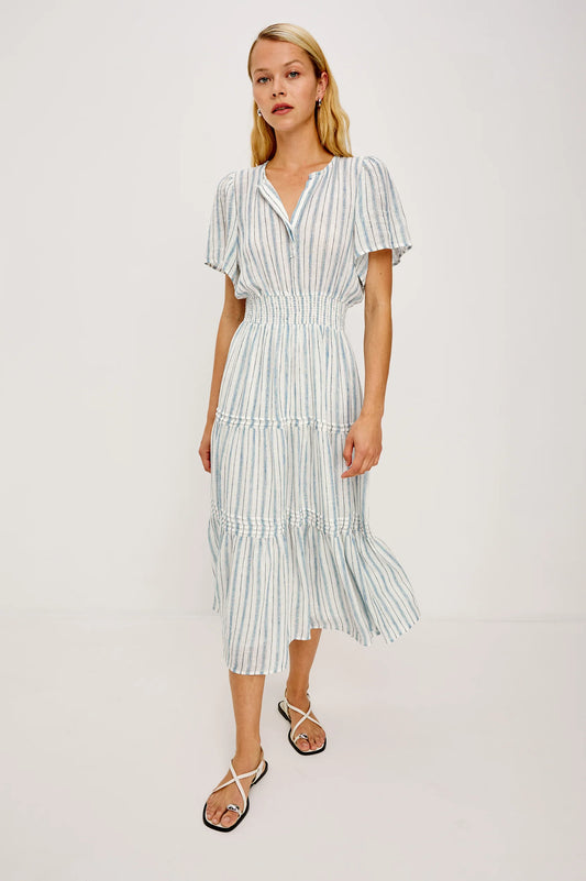 Woman wearing a Rails striped dress on a plain background