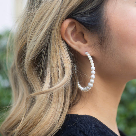 pearl hoops with gold fastening close up