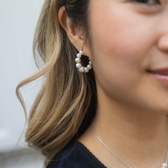 small pearl hoop earrings with silver back close up