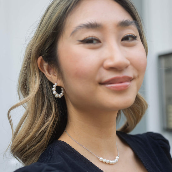 small pearl hoop earrings with silver back model shot