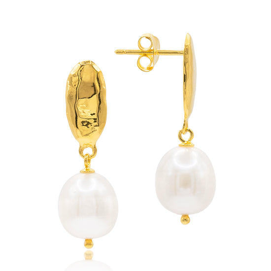 Gold earrings with white pearls by Claudia Bradby on a white background