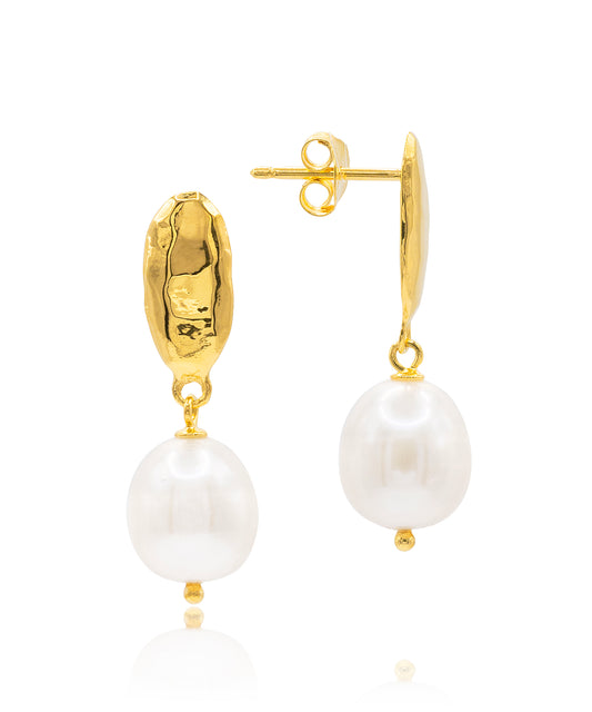 Gold earrings with white pearls by Claudia Bradby on a white background