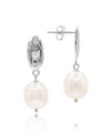 Pearl earrings by Claudia Bradby with silver hooks on a white background