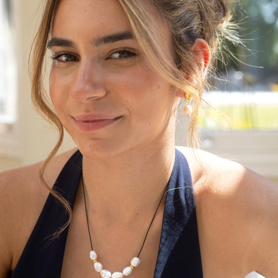 Woman wearing a necklace with pearls outdoors