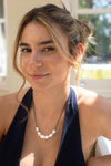 Woman wearing a necklace with pearls outdoors