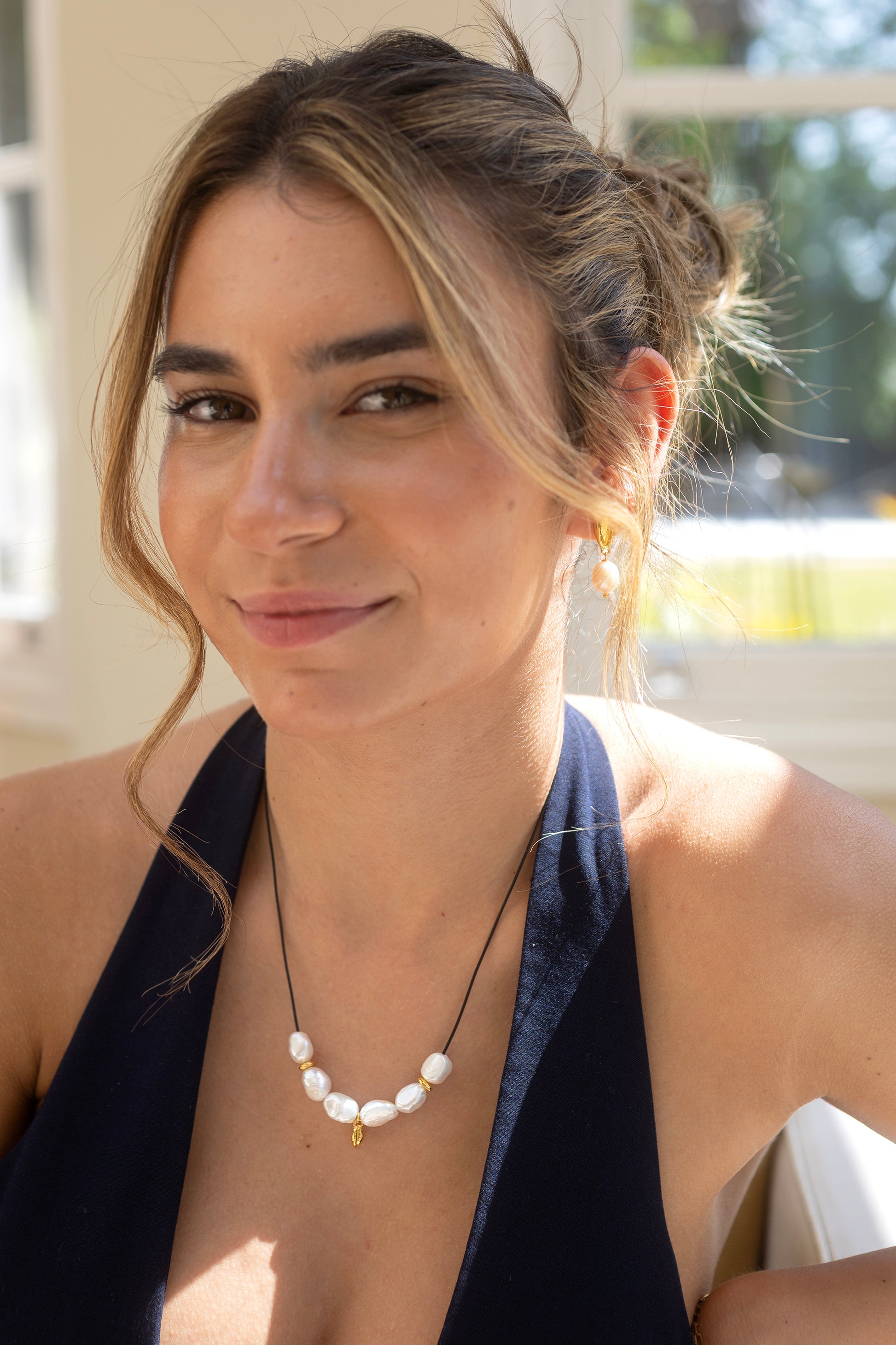 Woman wearing a necklace with pearls outdoors