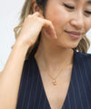 gold necklace with pendant and pearl model shot