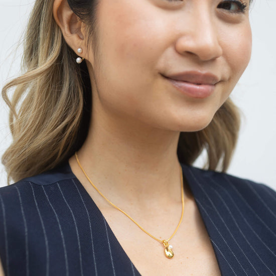 gold necklace with pendant and pearl model shot