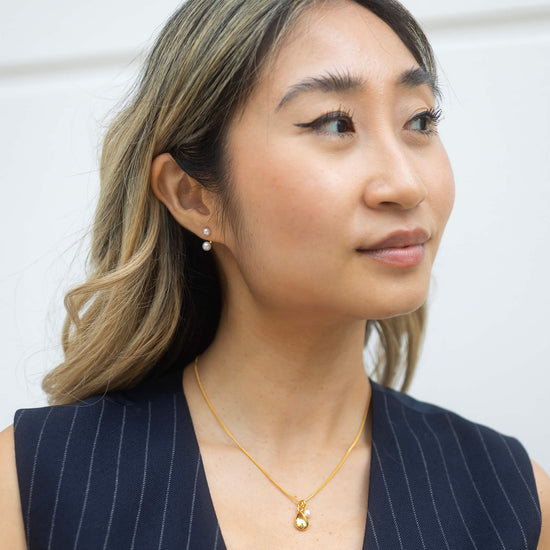 gold necklace with pendant and pearl model shot