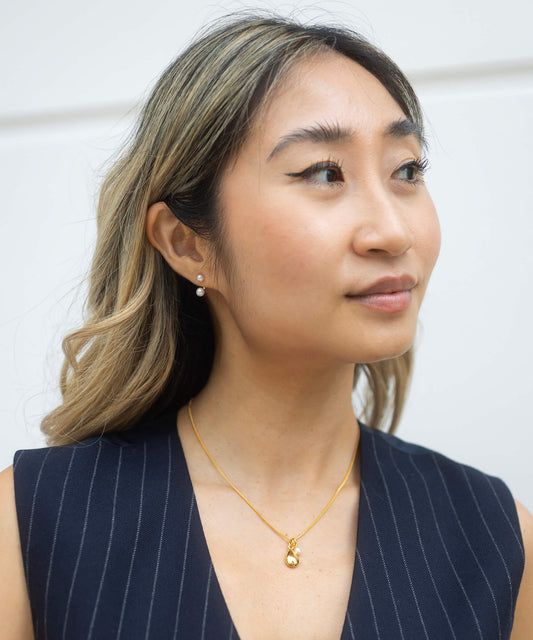 gold necklace with pendant and pearl model shot