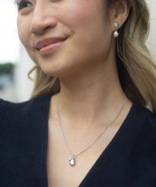 Silver necklace with pendant and pearl model shot