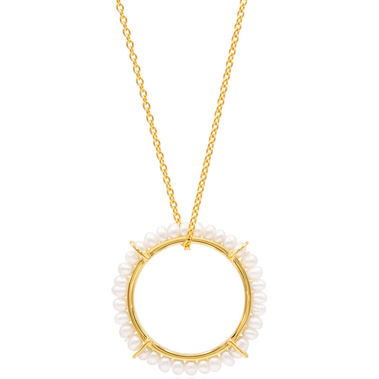 Gold necklace with a circular pendant featuring small pearls on a white background