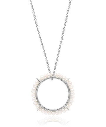 Silver necklace with a circular pendant featuring small pearls on a white background