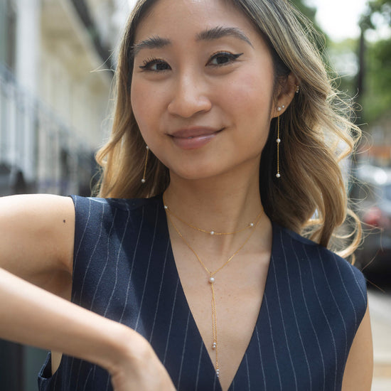 gold pearl lariat necklace model shot