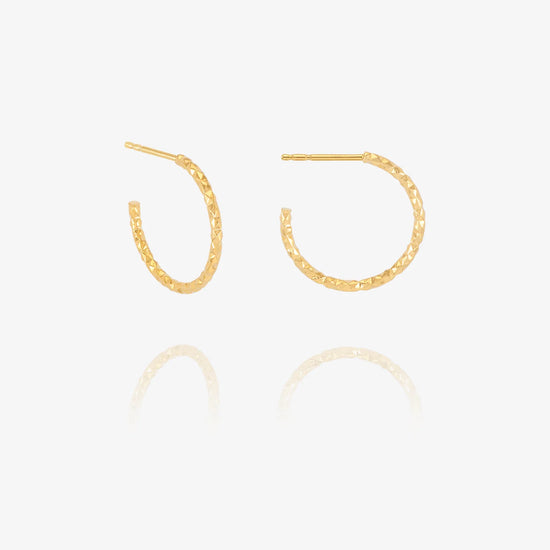 Gold hoop earrings on a white background