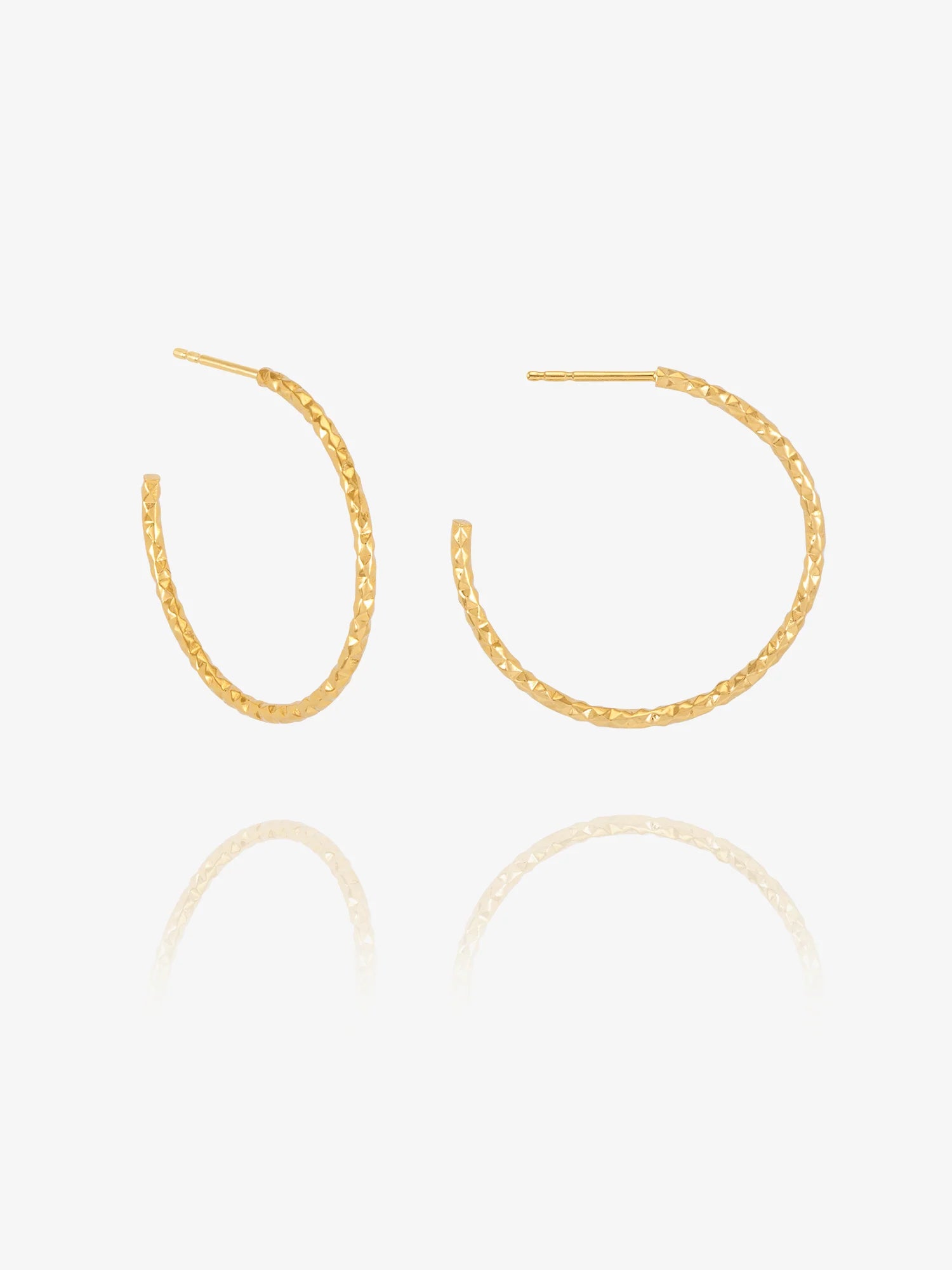 Gold hoop earrings on a white background