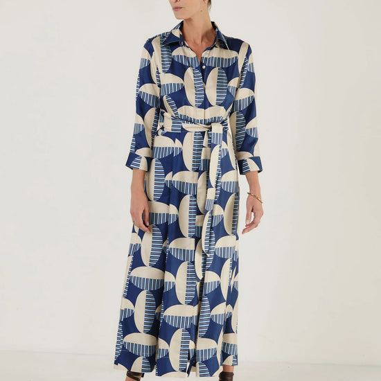 Woman wearing a blue and white patterned dress from Mondo Corsini on a white background