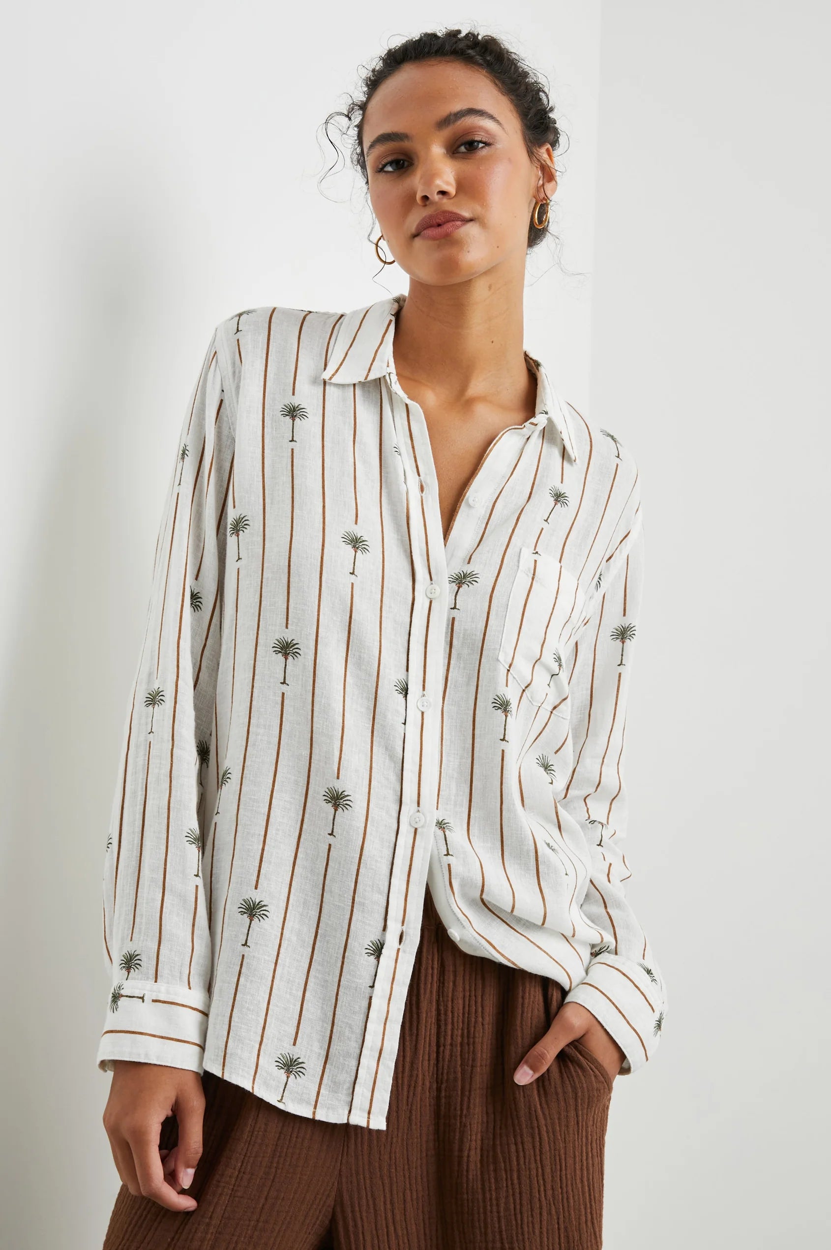 White linen blend shirt with classic collar and button through with brown vertical stripes and palm trees