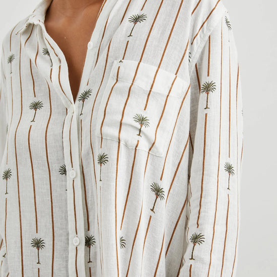 White linen blend shirt with classic collar and button through with brown vertical stripes and palm trees