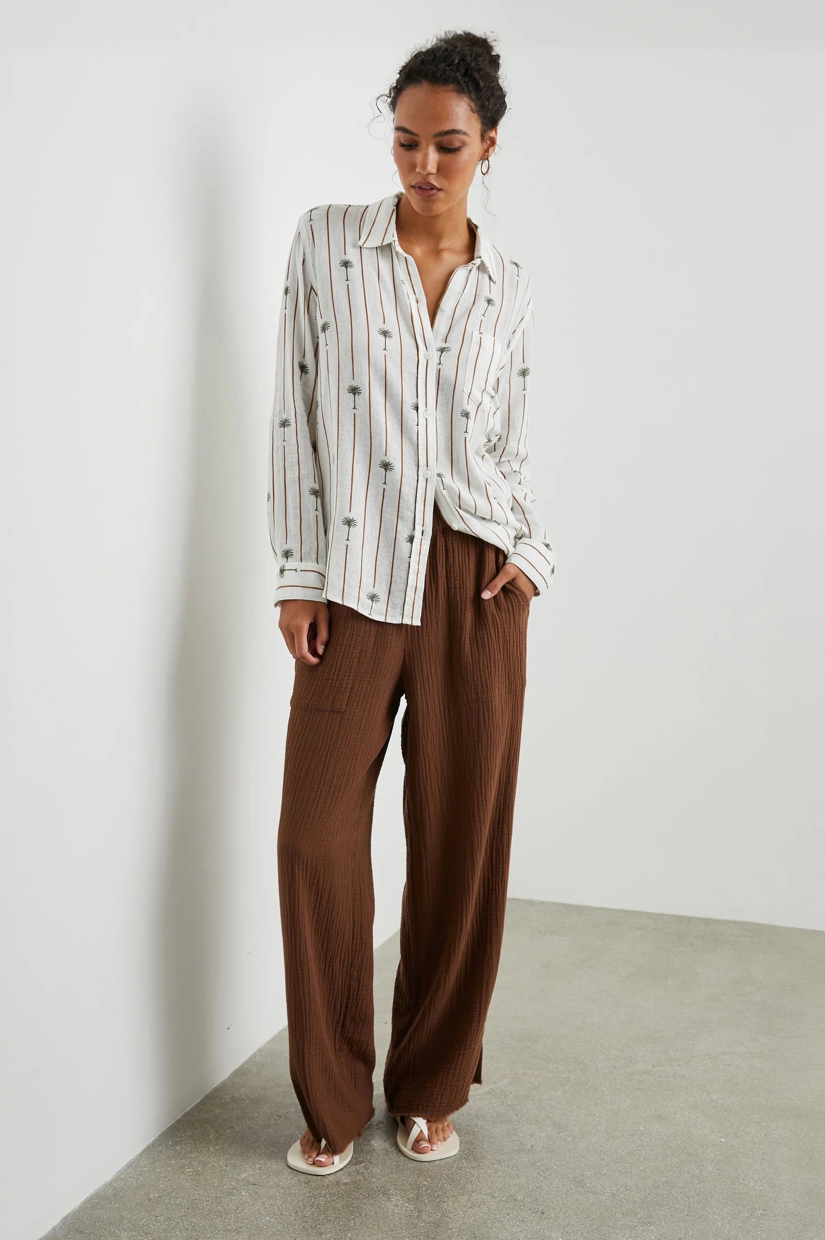 White linen blend shirt with classic collar and button through with brown vertical stripes and palm trees