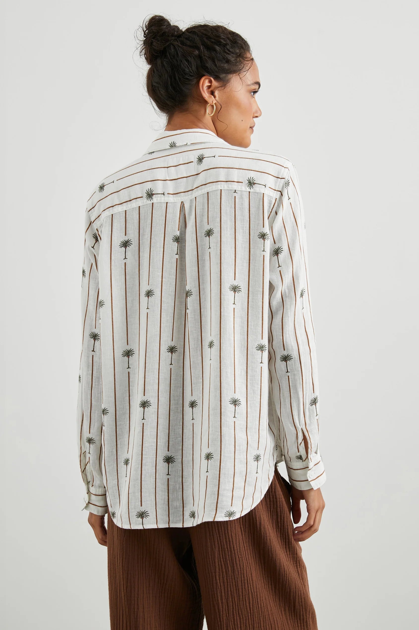 White linen blend shirt with classic collar and button through with brown vertical stripes and palm trees