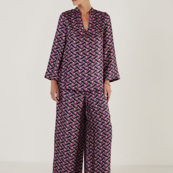 Printed silk top in a tunic style worn with matching wide leg trousers