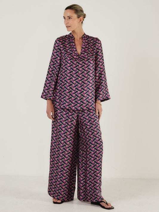 Printed silk top in a tunic style worn with matching wide leg trousers