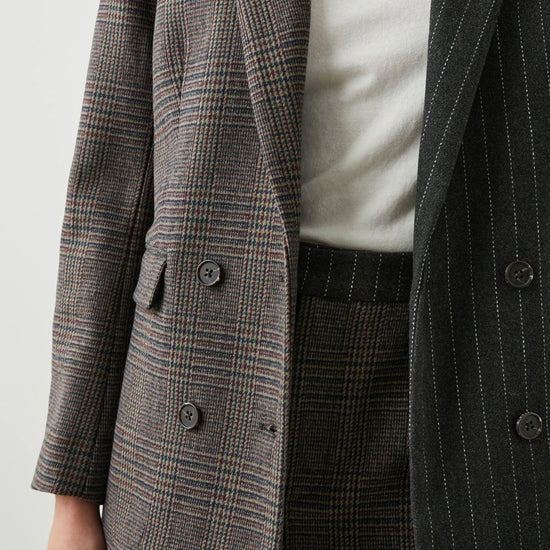 Contrast jacket with one side check design and the other pinstripe 