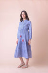 Blue midi dress with white ditsy print empire line with tie waist and red tassles with pintuck yoke features and long sleeves