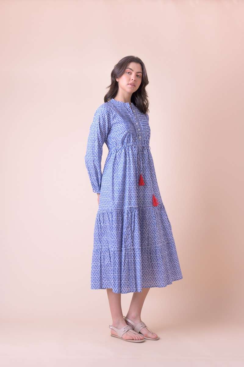 Blue midi dress with white ditsy print empire line with tie waist and red tassles with pintuck yoke features and long sleeves