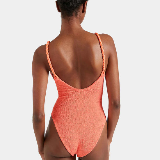 Rear view of Person wearing a coral swimsuit with thin straps on a white background from Hunza G