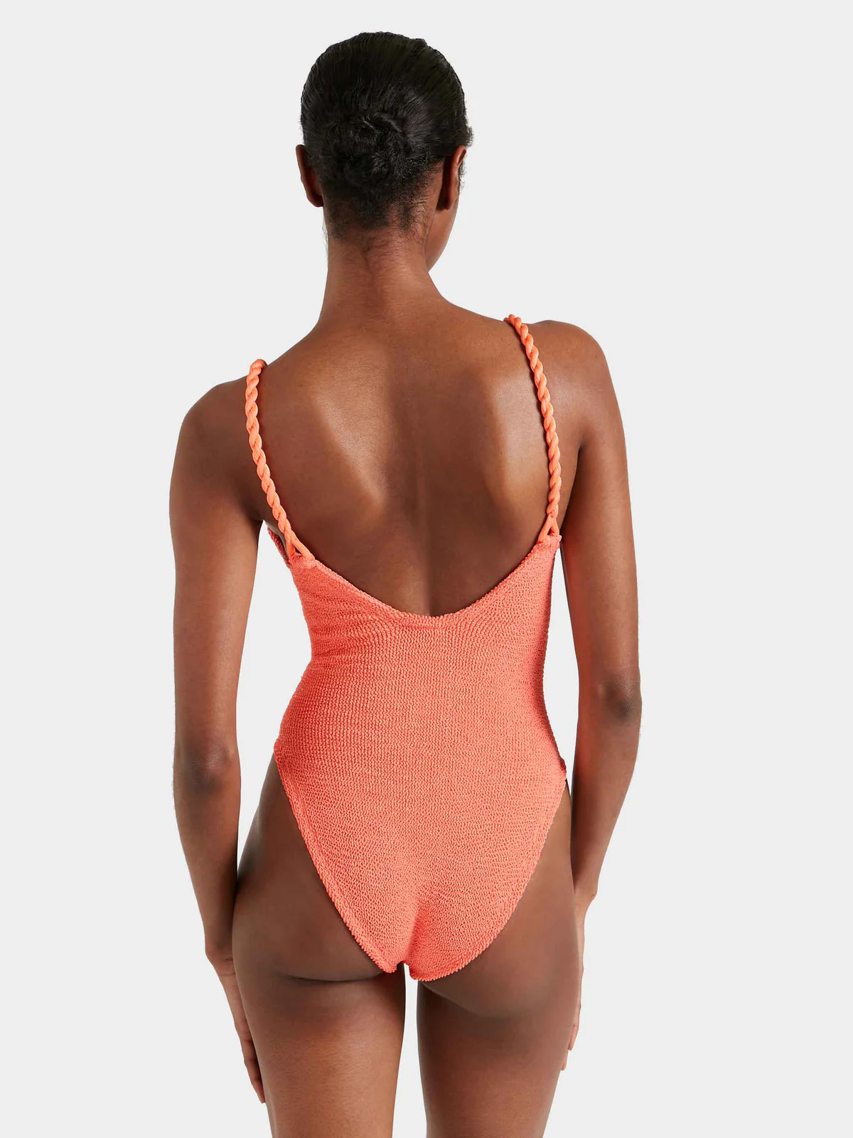 Rear view of Person wearing a coral swimsuit with thin straps on a white background from Hunza G
