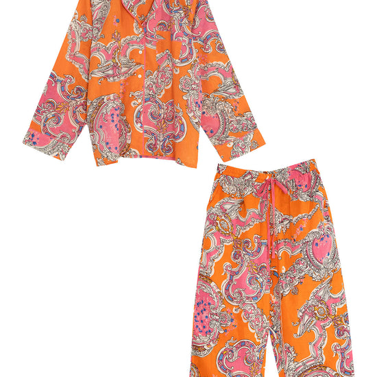 Orange and pink patterned shirt and pants set on a white background