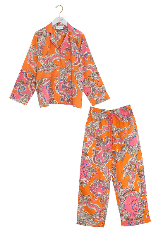 Orange and pink patterned shirt and pants set on a white background