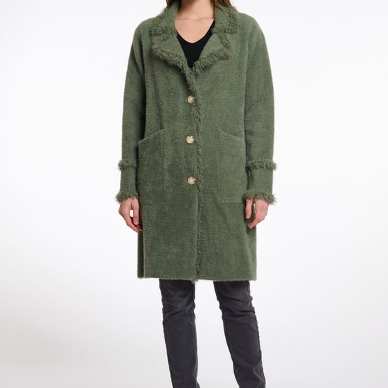 green fluffy long cardigan which comes just above the knee with fringe detailing patch pockets and long sleeves