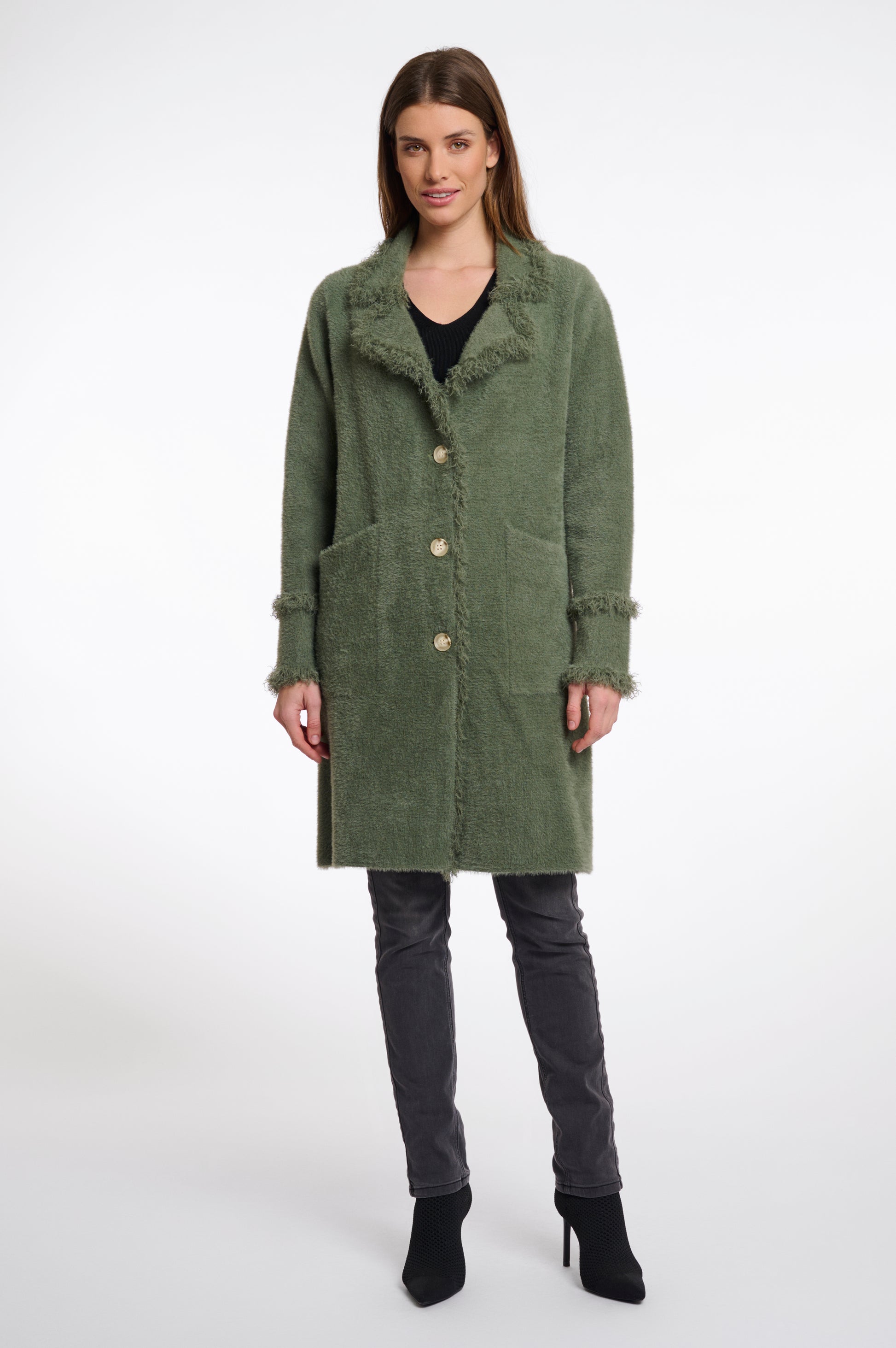 green fluffy long cardigan which comes just above the knee with fringe detailing patch pockets and long sleeves
