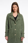 green fluffy long cardigan which comes just above the knee with fringe detailing patch pockets and long sleeves close up