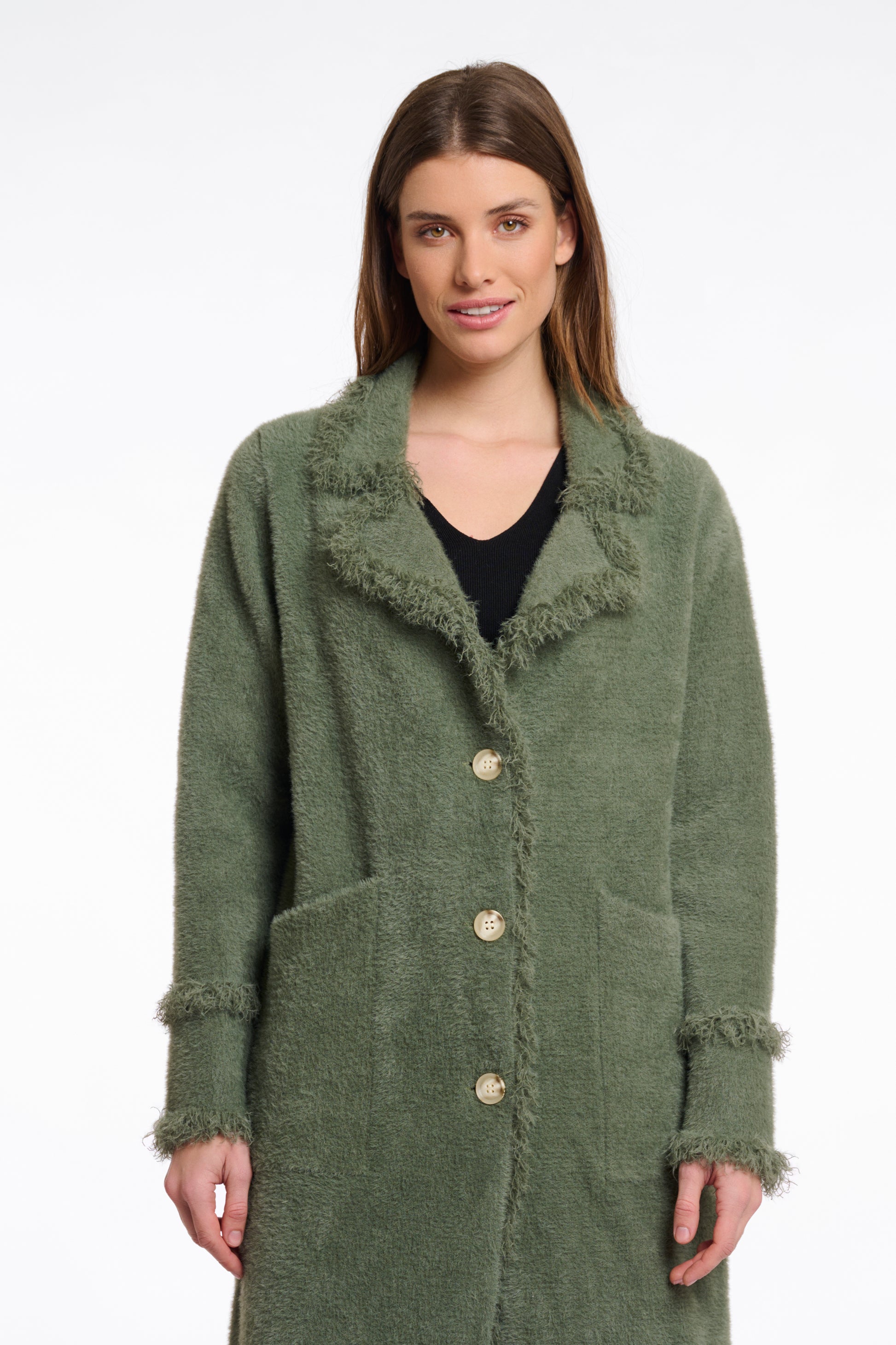 green fluffy long cardigan which comes just above the knee with fringe detailing patch pockets and long sleeves close up