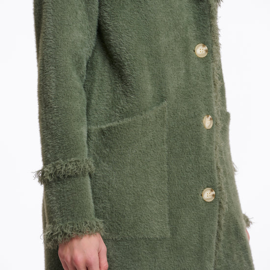 green fluffy long cardigan which comes just above the knee with fringe detailing patch pockets and long sleeves side view