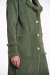 green fluffy long cardigan which comes just above the knee with fringe detailing patch pockets and long sleeves side view