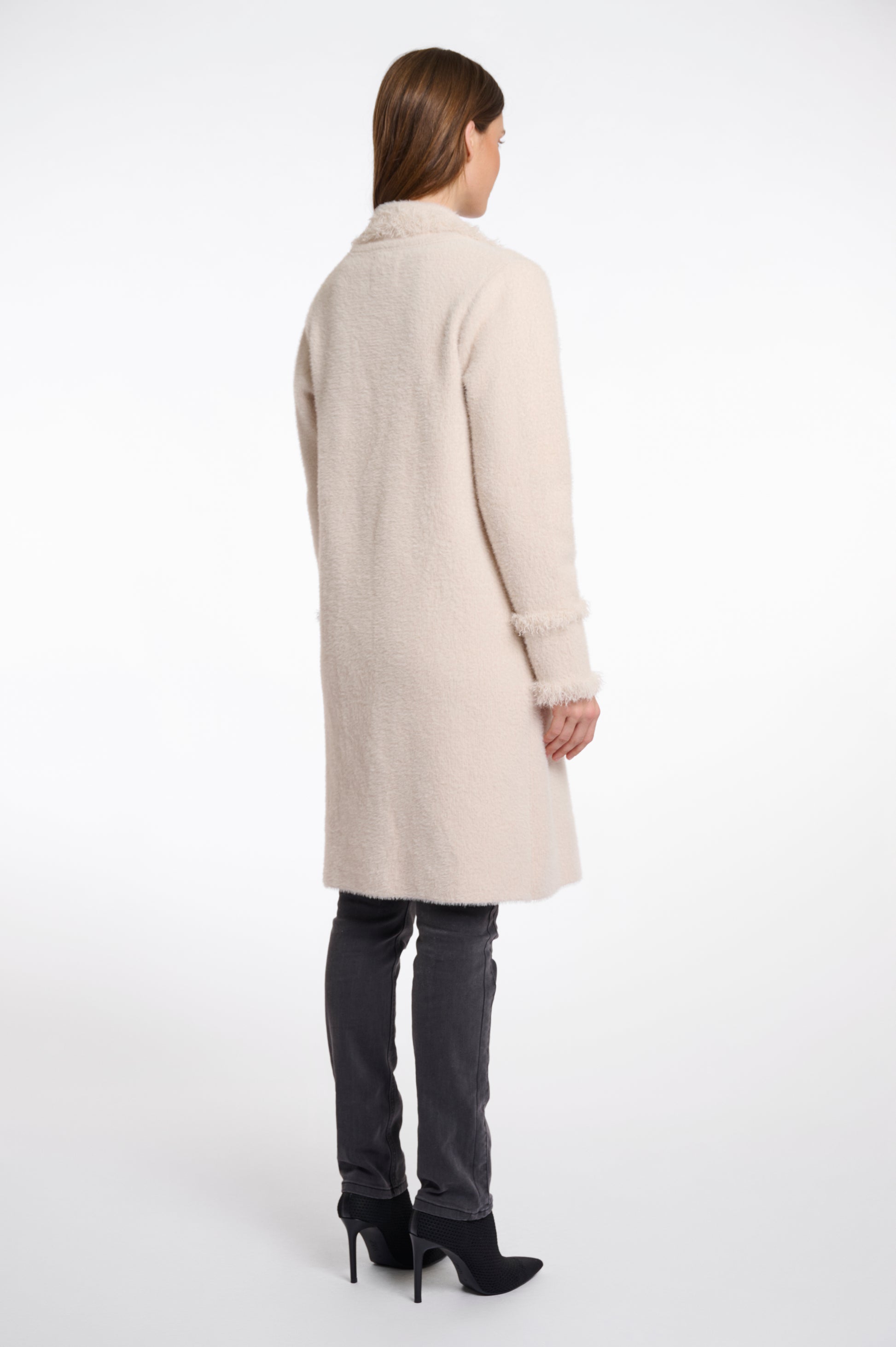pale pink fluffy long cardigan which comes just above the knee with fringe detailing patch pockets and long sleeves rear view