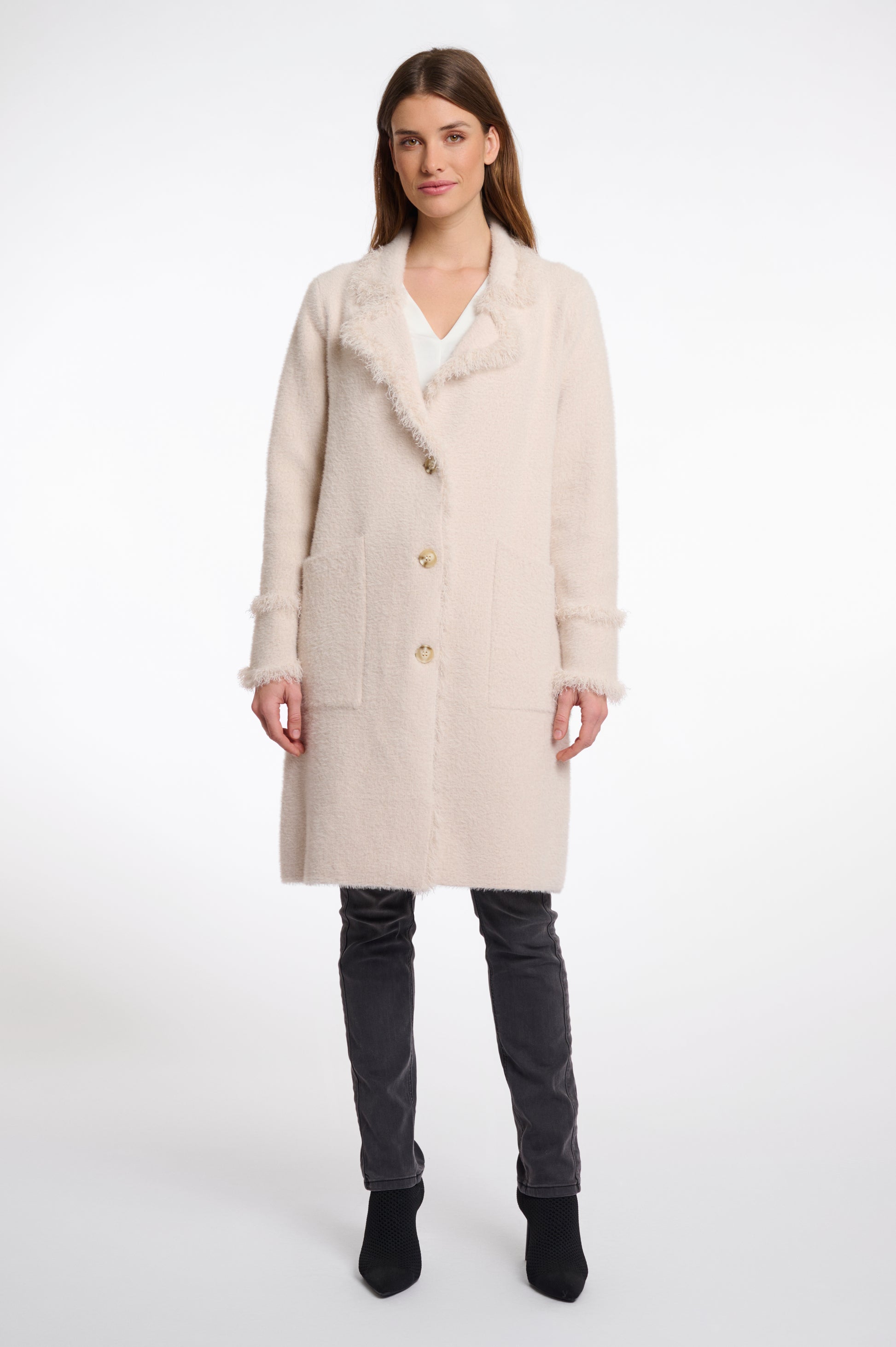 pale pink fluffy long cardigan which comes just above the knee with fringe detailing patch pockets and long sleeves