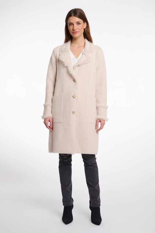 pale pink fluffy long cardigan which comes just above the knee with fringe detailing patch pockets and long sleeves