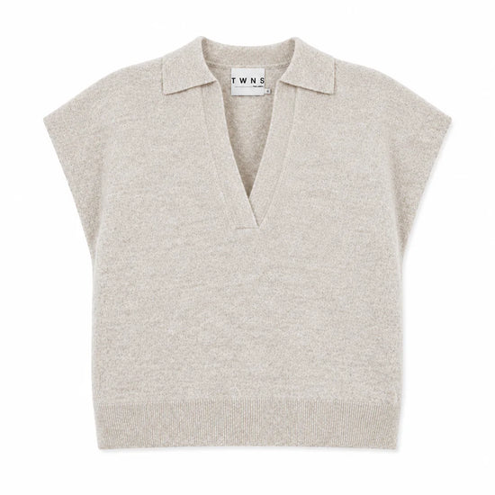 A light beige knit polo sweater vest with short cap sleeves and a V-neck collar, shown flat on a white background. The brand name 'TWINE' is visible on the inner neck label.