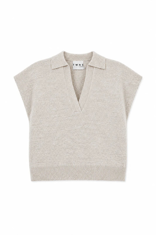 A light beige knit polo sweater vest with short cap sleeves and a V-neck collar, shown flat on a white background. The brand name 'TWINE' is visible on the inner neck label.