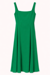 Green dress with thin straps on a white background.