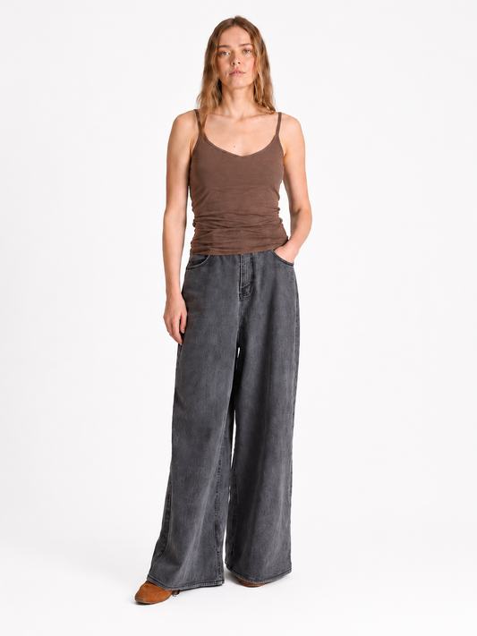 brown strappy top and grey jeans